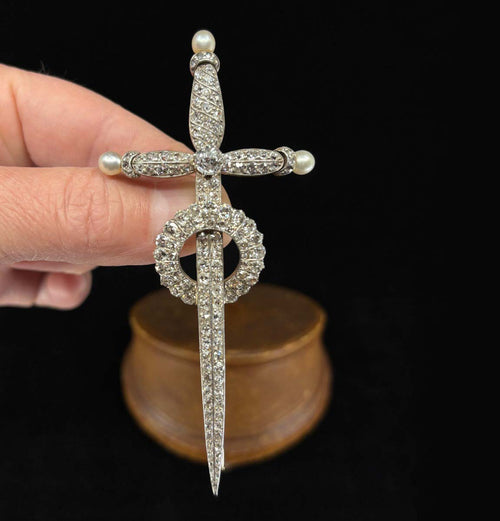 Close-up detail of antique Victorian sword brooch blade and wreath pavé with old-cut diamonds on a rose-gold base.