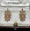Antique Etruscan revival coral earrings showing cannetille scrollwork and coral cabochons
