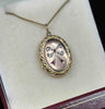 Antique Victorian locket crafted from 9ct yellow gold adorned with an intricate bow design.