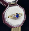 Antique style claw‑set sapphire and diamond ring from the 1950s, featuring a deep blue 0.50ct sapphire and two G VS diamonds in an 18ct yellow gold setting.
