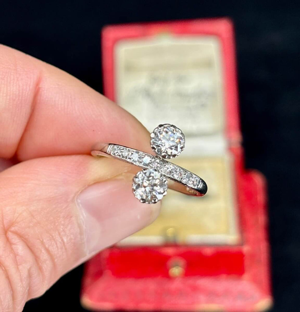 Antique 1920s Old European cut diamond ring with two old European cut stones set in platinum and nine single cut diamonds on the band.