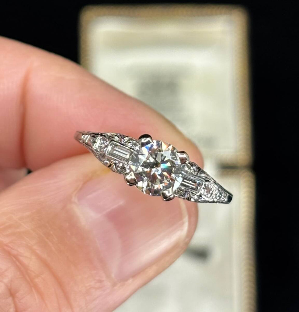 1920s Art Deco 1.25ct diamond ring in platinum with round centre stone, baguette accents and pavé shoulders.