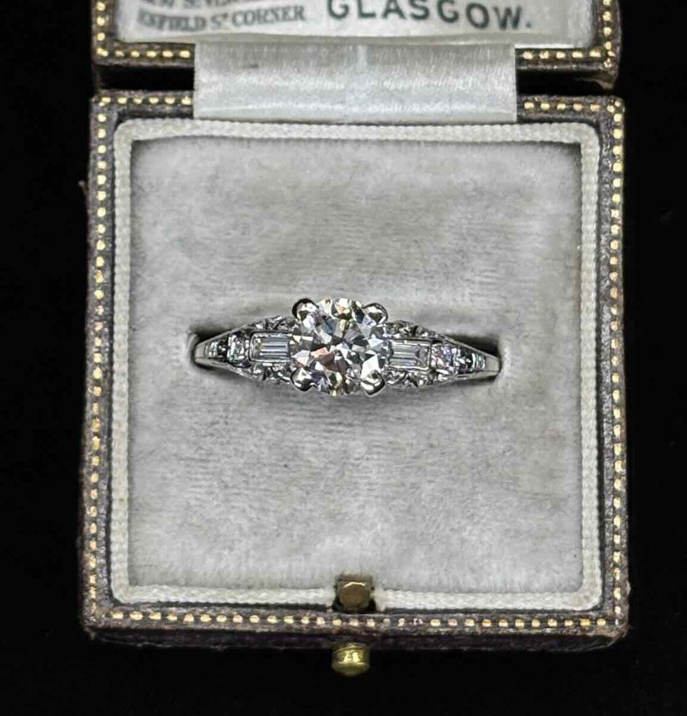 Antique Art Deco engagement ring 1.25ct round brilliant with geometric baguette details and pavé set shoulders in an antique box.