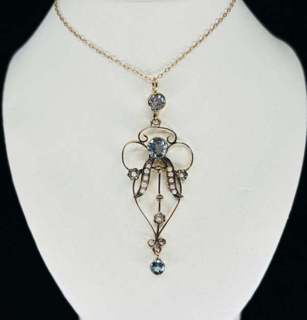 antique 9ct yellow gold aquamarine pendant with small pearl and swirling art nouveau design gold surround