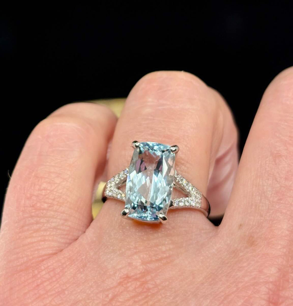 Cushion cut aquamarine ring in white gold with diamond accents.