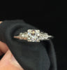 Close-up of a 1920s Art Deco platinum ring with a 0.46ct semi‑modern cut diamond and carved pavé shoulders.