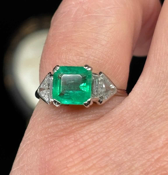 Art Deco emerald ring by Birks of Canada, 1.25ct emerald with shield and baguette diamonds on platinum band, vintage 1930s.