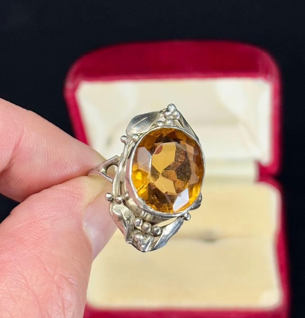Gum leafs surround this collectible piece of wearable art made in the 1930s by jewellery designer Rhoda Wager