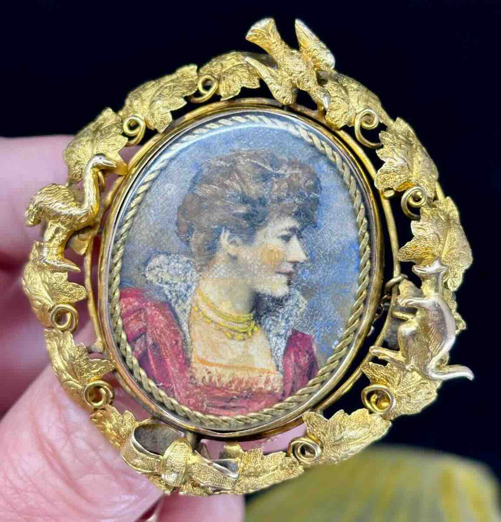 Australian colonial 15ct gold locket with emu, kangaroo, doves and vines bordering a hand painted portrait of a prominent woman of elite social standing.