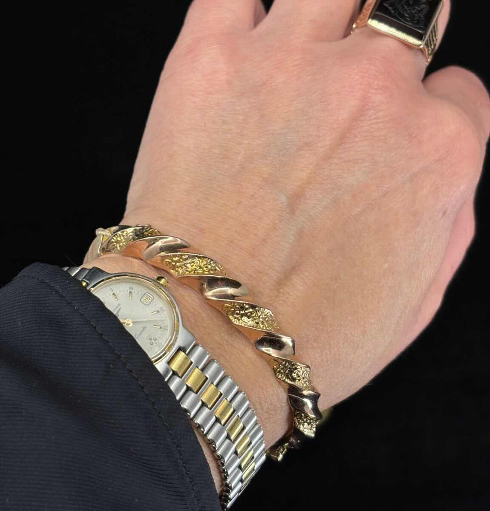 Australian Colonial Willis & Co repoussé hinged bangle in 9ct yellow gold, Edwardian era circa 1905 — wearable heirloom and collectible jewellery photographed on the arm.