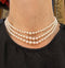 Classic three-strand Akoya pearl necklace with cream rose pearls and diamond clasp.