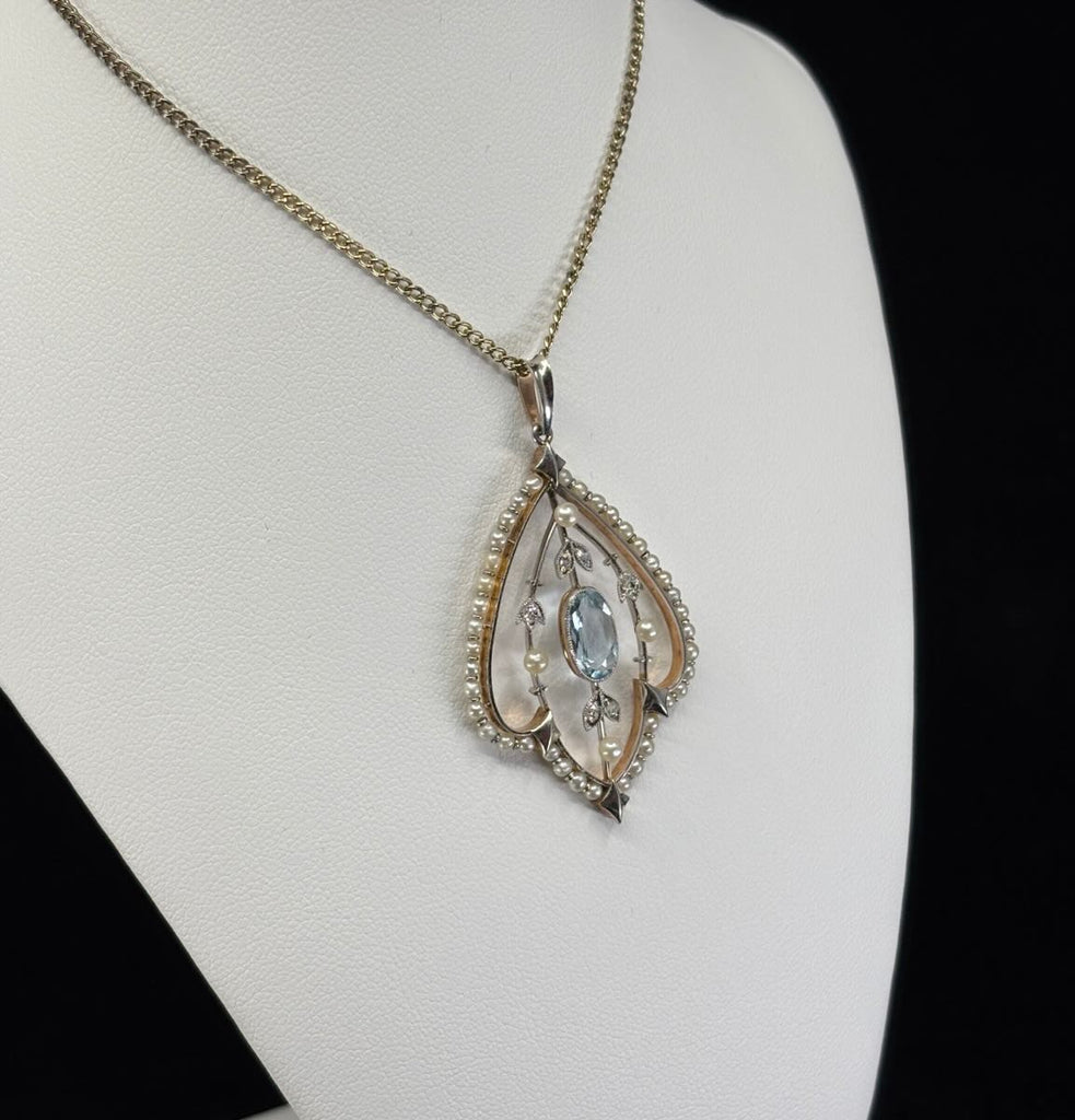 Collectible Edwardian aquamarine, pearl and diamond pendant with teardrop silhouette and intricate early 20th‑century craftsmanship.