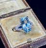 Cushion mixed cut aquamarine ring highlighted by diamonds.