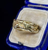 Detail of early Victorian gimmel ring showing interlocking gold bands and engraved shoulders