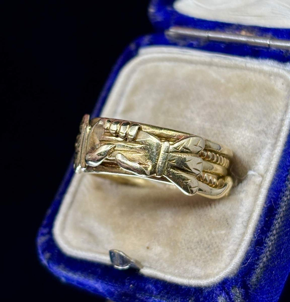 Detail of early Victorian gimmel ring showing interlocking gold bands and engraved shoulders