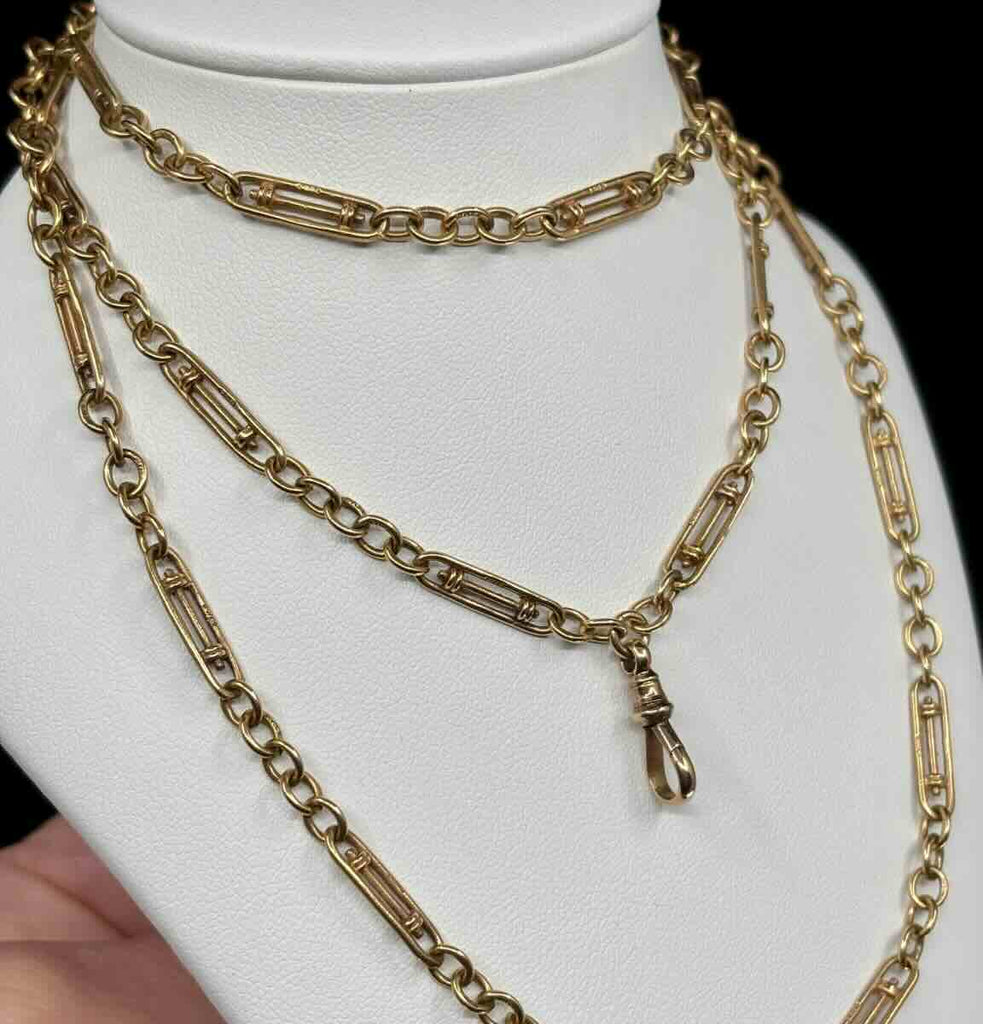 Edwardian circa 1900 9ct yellow gold guard chain 84cm with rare elongated link pattern on display — mint condition antique pocket watch chain.