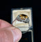 Elegant imperial topaz ring with a diamond halo, perfect for special occasions.