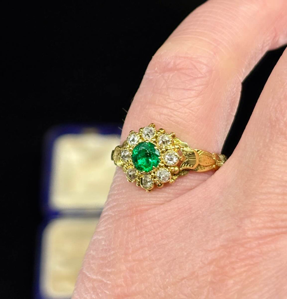 Engraved Victorian ring showcasing a fine green emerald and diamond cluster.