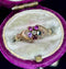 Victorian engagement ring with Fede hands design and symbolic gemstone arrangement.