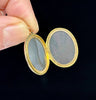 Gold locket from the Victorian era featuring a symbolic bow motif, made in 9ct yellow gold.
