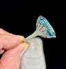 Bespoke aquamarine ring featuring diamond-encrusted fan-style shoulders
