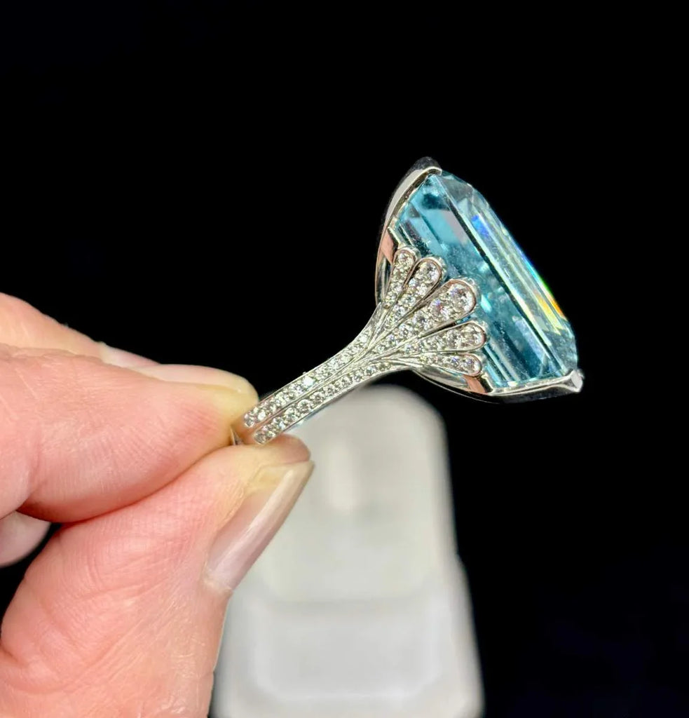 Bespoke aquamarine ring featuring diamond-encrusted fan-style shoulders