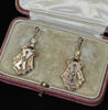 Detail view of Victorian 9ct rose gold articulated drop earrings with engraved escutcheon-style panels and natural seed pearls.