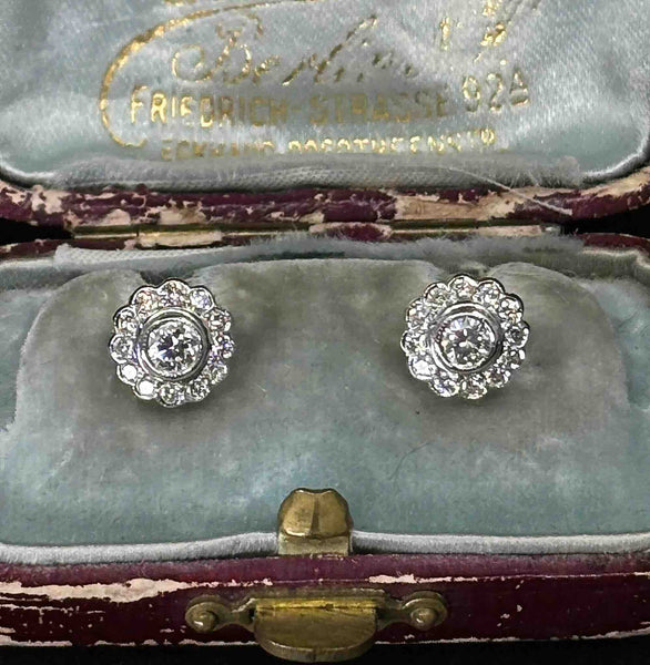 Pair of diamond posy cluster stud earrings in 18ct white and yellow gold, displayed in their fitted presentation case.