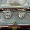 Pair of diamond posy cluster stud earrings in 18ct white and yellow gold, displayed in their fitted presentation case.
