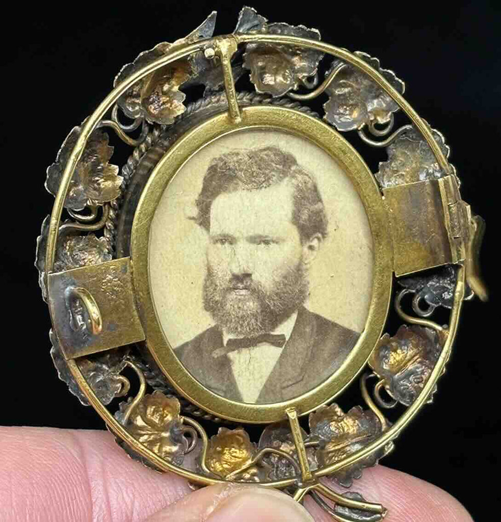 Victorian-era locket adorned with stylised leaves and floral designs, highlighting craftsmanship.