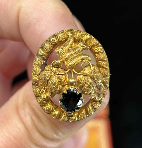 Close-up of Lamborn and Wagner dove motif on a colonial Australian brooch in 15ct yellow gold with rope frame.