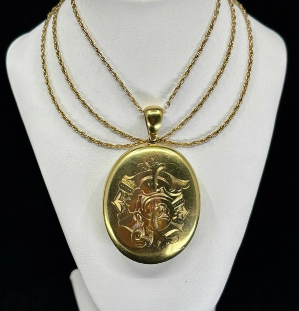 Late Victorian 15ct yellow gold oval locket (circa 1900) with hand‑engraved monogram, wearable antique family heirloom.