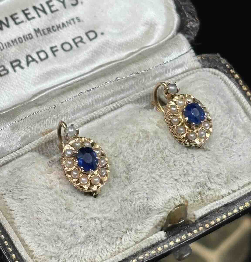 Late Victorian sapphire earrings featuring royal blue 0.28ct sapphires surrounded by natural seed pearls in claw settings, 18ct yellow gold.