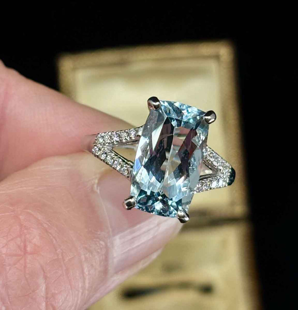 Light blue aquamarine ring with diamonds set in white gold.