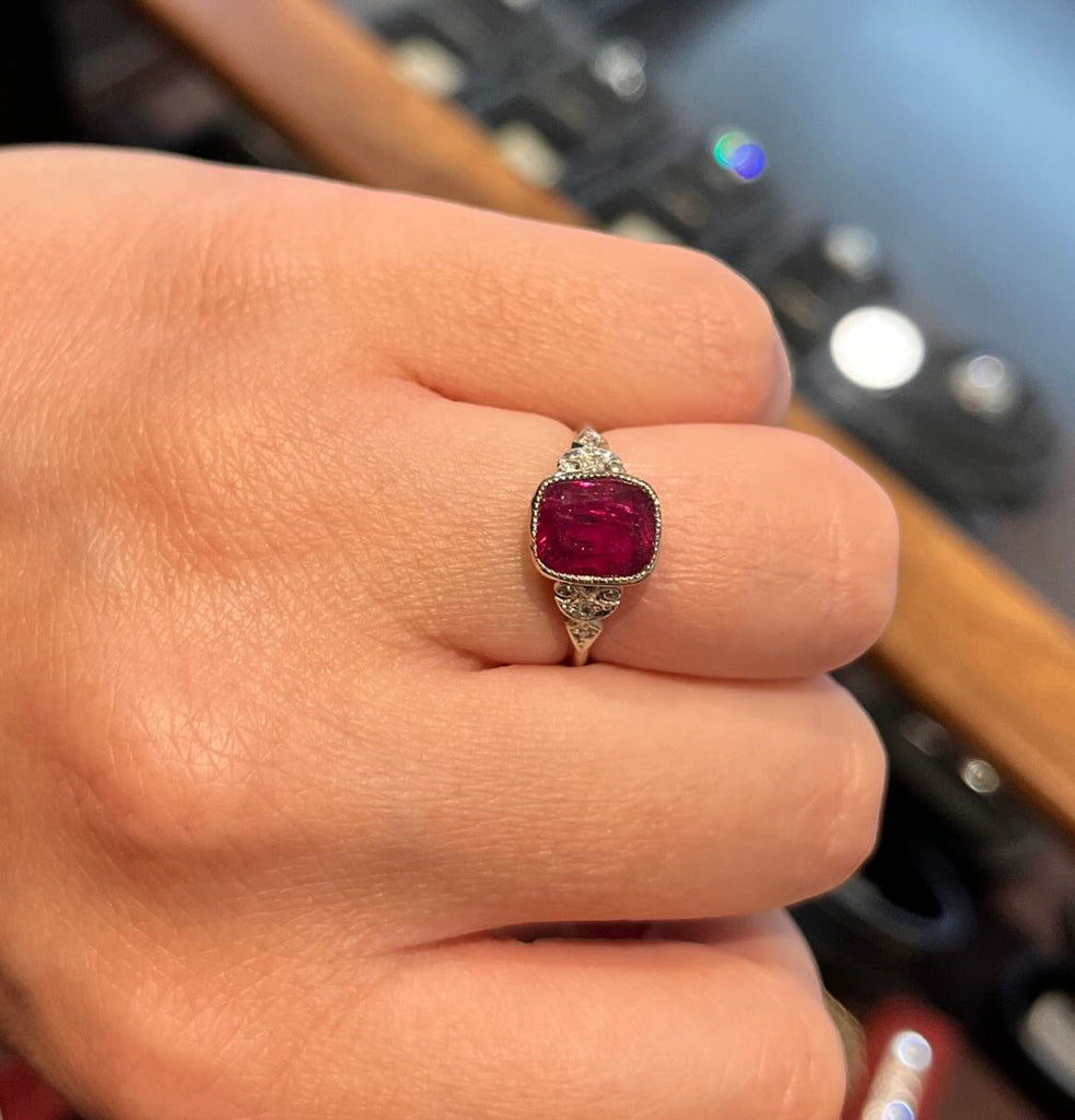 Natural untreated ruby bezel ring (GSL report) set in 18ct white gold and platinum with single‑cut diamond accents and intricate hand‑crafted shoulders.