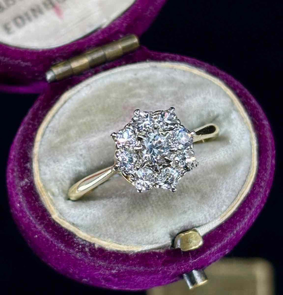 a side view of the antique flower cluster in an antique ring box
