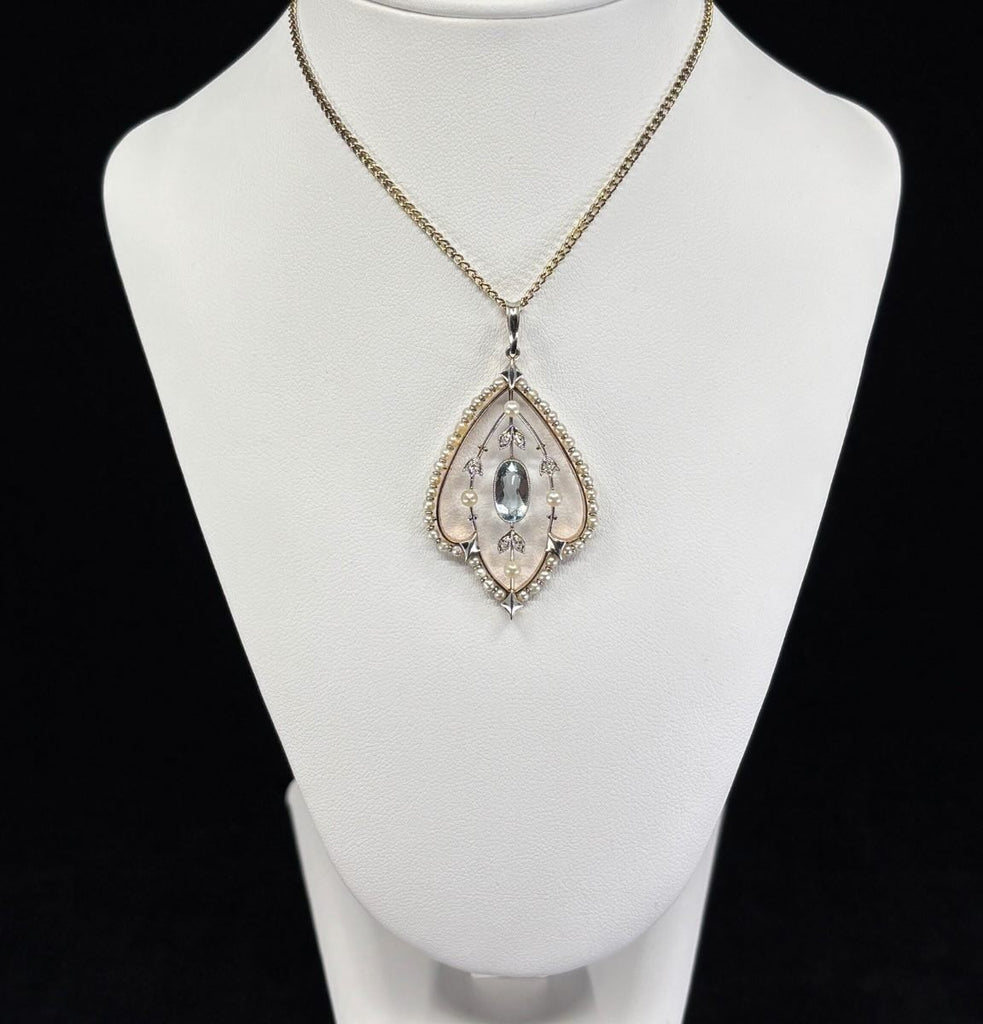 Oval aquamarine (0.85ct) surrounded by 38 seed pearls, three additional pearls and rose & mine‑cut diamonds in an Art Nouveau setting.