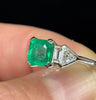 Platinum Art Deco emerald ring, vintage Birks craftsmanship, emerald 6.9x6.9mm with diamond shoulder accents.
