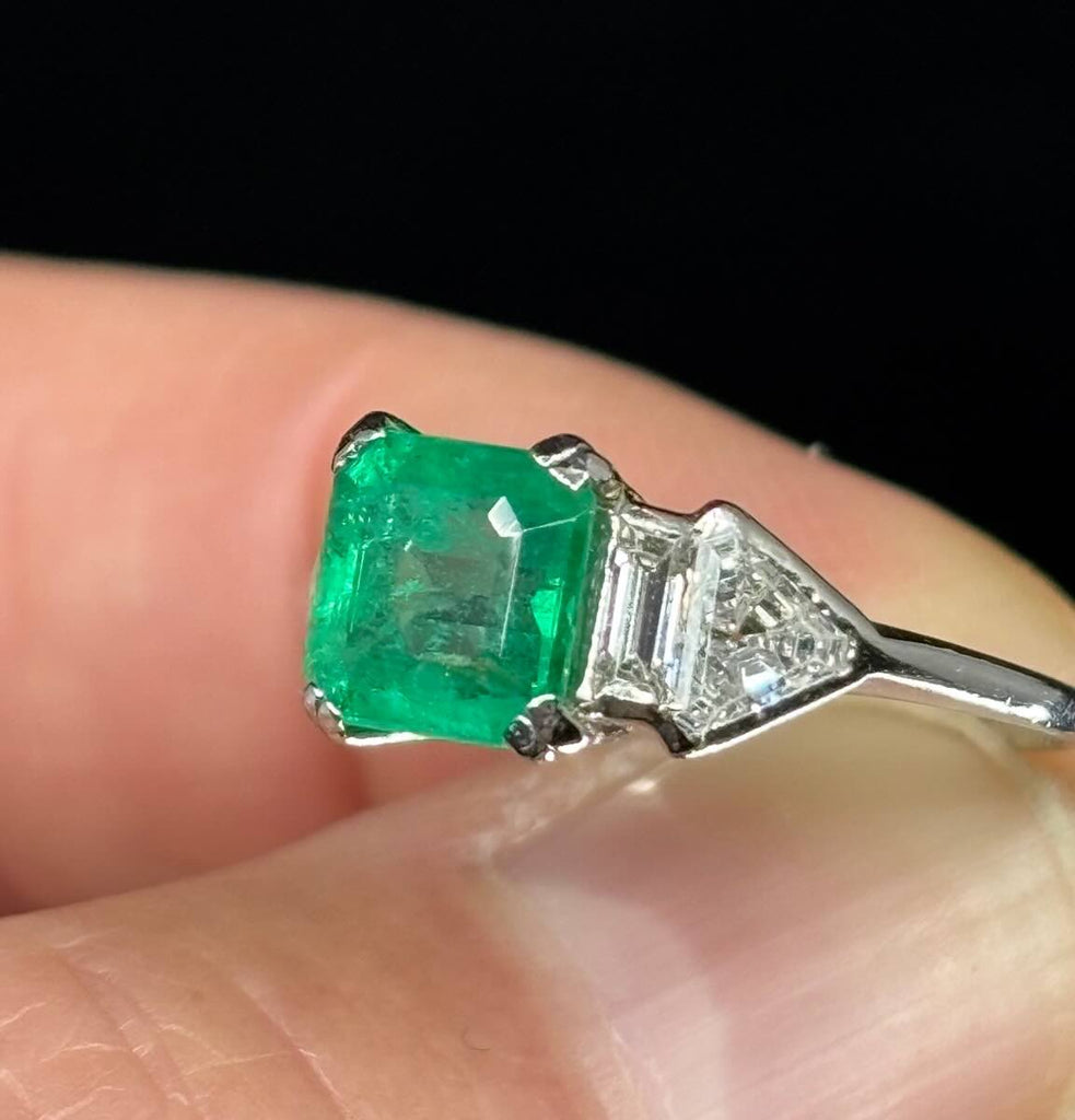 Platinum Art Deco emerald ring, vintage Birks craftsmanship, emerald 6.9x6.9mm with diamond shoulder accents.