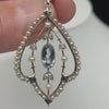 Close up  of the aquamarine, diamond and pearl details in the art nouveau pendant