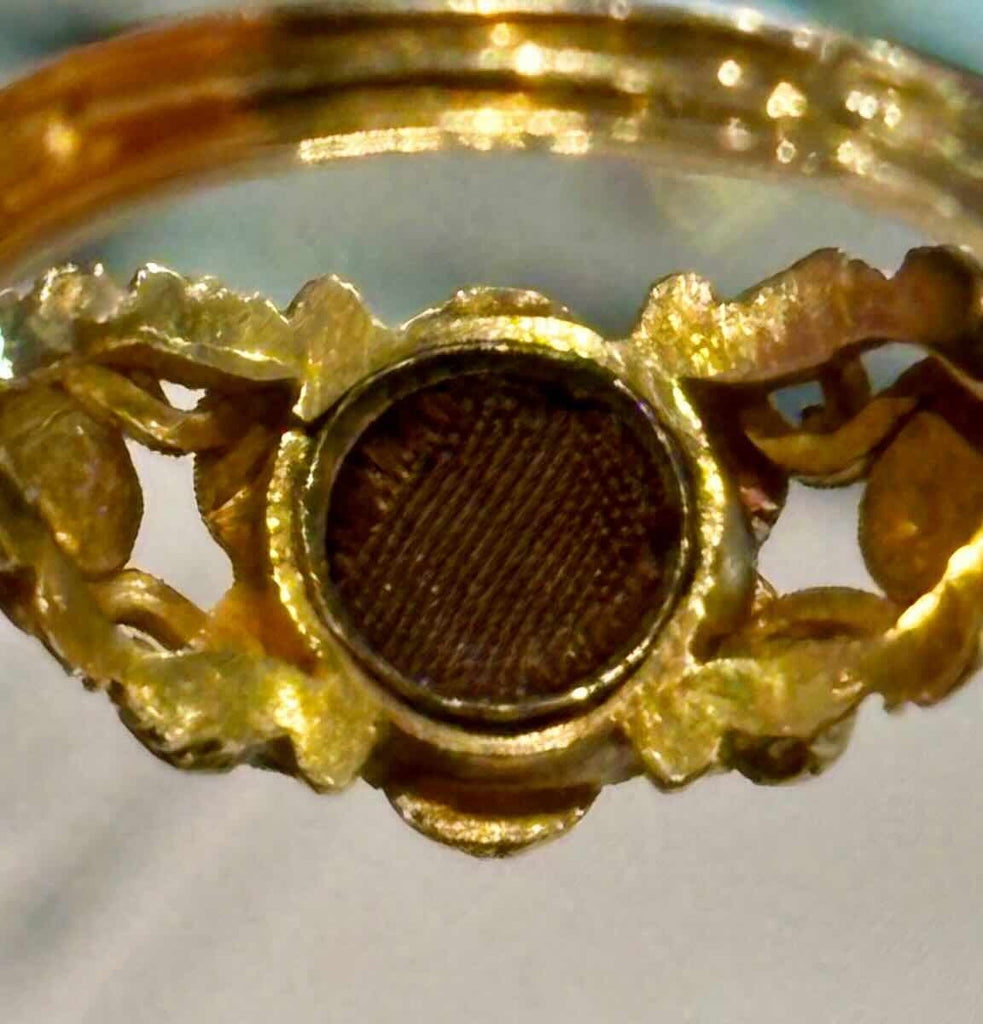The underside of the Victorian ring setting revealing a secret locket compartment.