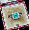 1950s square cut emerald ring accented with sparkling diamonds.