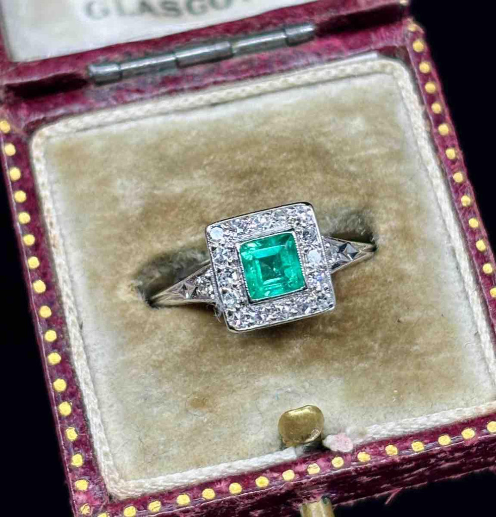 1950s square cut emerald ring accented with sparkling diamonds.