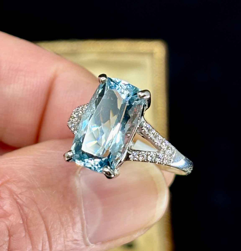 Stunning aquamarine ring with diamond accents on a white gold band.