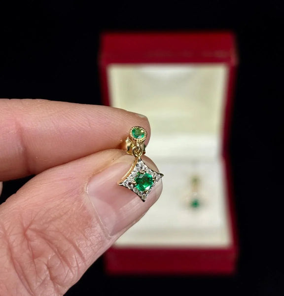 Stylish earrings with emerald and diamond accents.