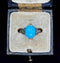 Elegant 1920s style jewellery featuring a stunning turquoise and diamond ring, emphasising the rich color of the turquoise and the sparkle of the diamonds.