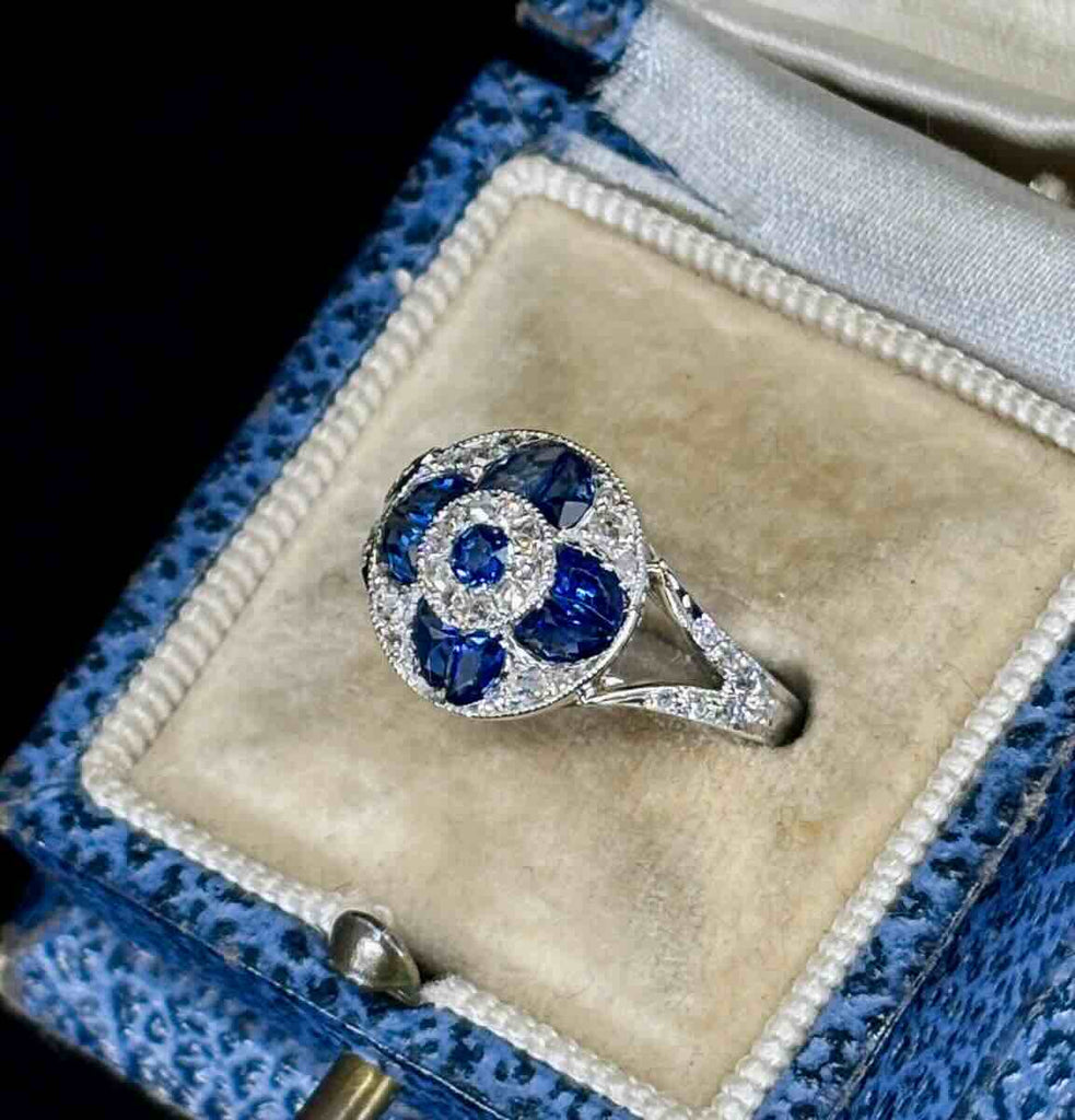 Unique art deco heirloom sapphire and diamond ring showcasing the side view with a flat profile to fit snug on the finger.