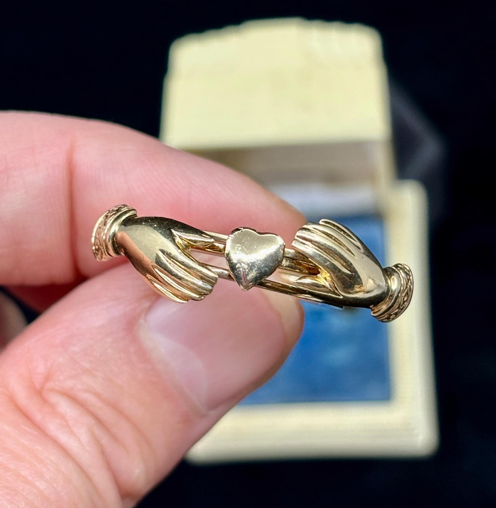Side view of Victorian gold fede gimmel ring with interlocking bands and heart detail