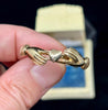 Side view of Victorian gold fede gimmel ring with interlocking bands and heart detail