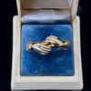 Victorian fede gimmel ring in yellow gold displayed in antique box showing clasped hands design.